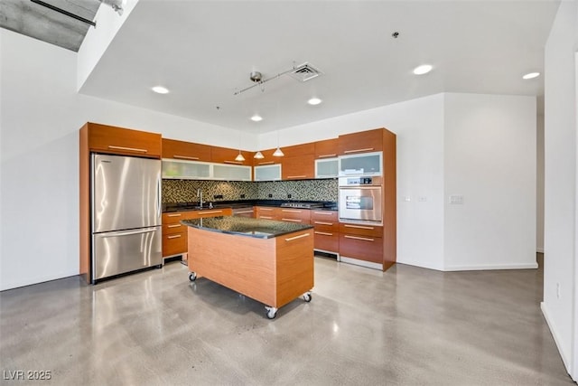 kitchen featuring visible vents, concrete floors, backsplash, and stainless steel appliances