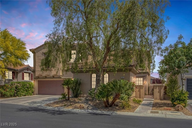 obstructed view of property featuring a garage, stucco siding, a tile roof, and concrete driveway