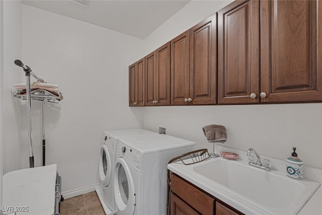 laundry room with a sink, separate washer and dryer, baseboards, and cabinet space
