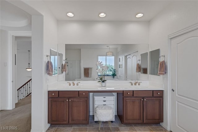 full bathroom with double vanity and a sink
