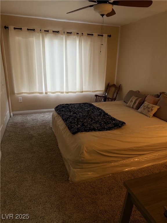 bedroom with a ceiling fan and carpet flooring