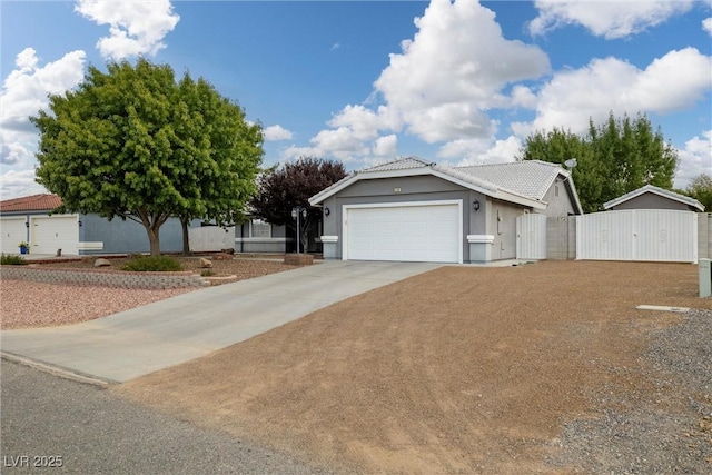5200 Wheatland Dr, Pahrump, NV 89061 - ranch-style house with a garage, stucco siding, a gate, a tiled roof, and concrete driveway