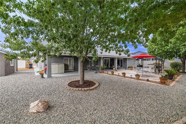 5200 Wheatland Dr, Pahrump, NV 89061 - back of property featuring a patio and stucco siding