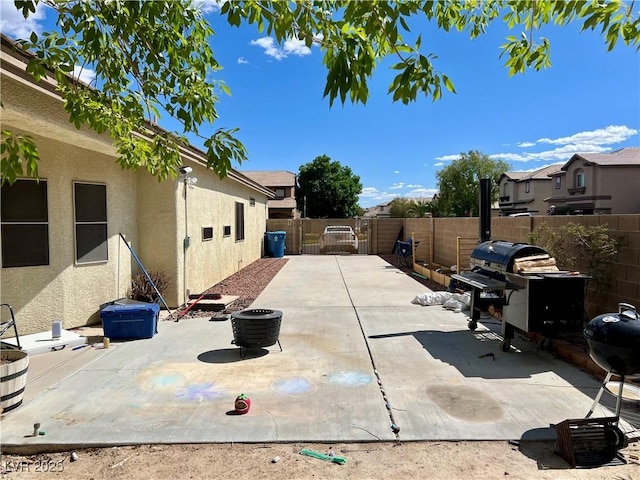 view of patio / terrace featuring a fenced backyard, a gate, and area for grilling
