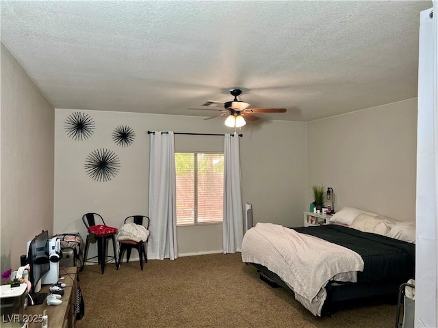 bedroom featuring carpet floors, a ceiling fan, and a textured ceiling