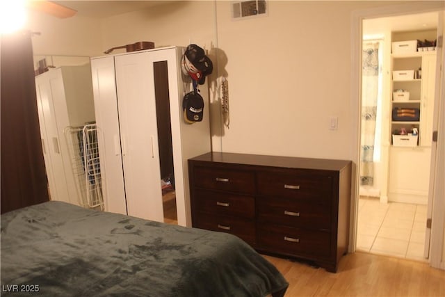 bedroom featuring visible vents and light wood-style flooring