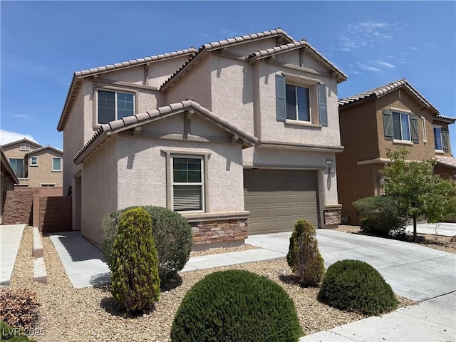 view of front facade featuring a garage, driveway, and stucco siding
