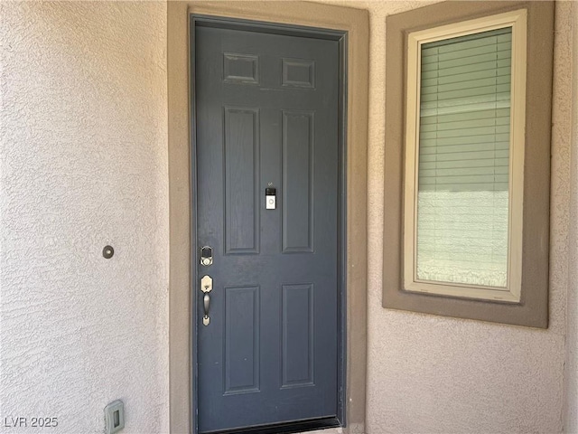 doorway to property with stucco siding