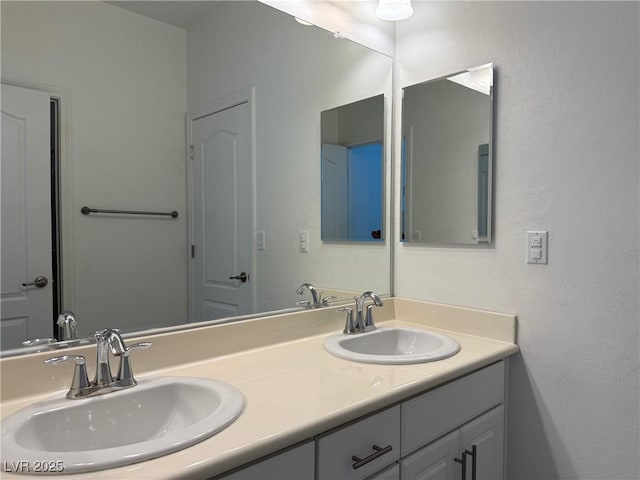 full bathroom with double vanity and a sink