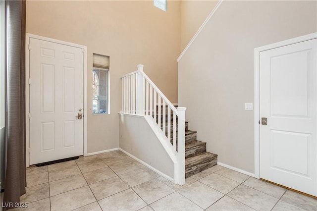 3163 Biccari Ave, Henderson, NV 89044 - entrance foyer with a towering ceiling, stairway, light tile patterned flooring, and baseboards