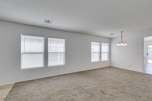8877 Perfect Diamond Ct, Las Vegas, NV 89129 - spare room with an inviting chandelier, baseboards, visible vents, and light carpet