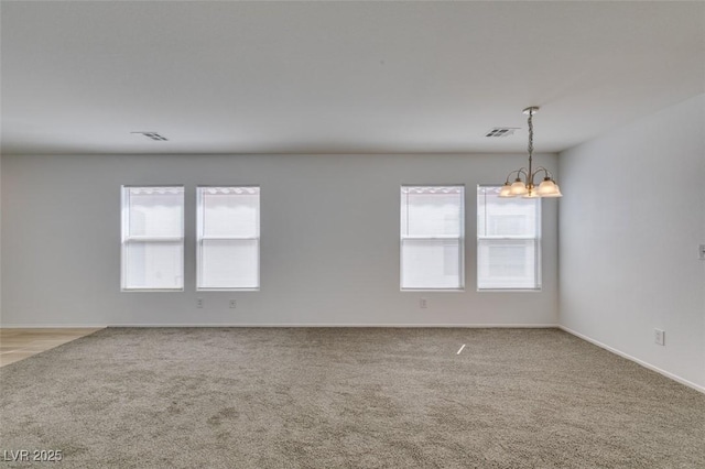 8877 Perfect Diamond Ct, Las Vegas, NV 89129 - empty room featuring a notable chandelier, light carpet, a healthy amount of sunlight, and visible vents