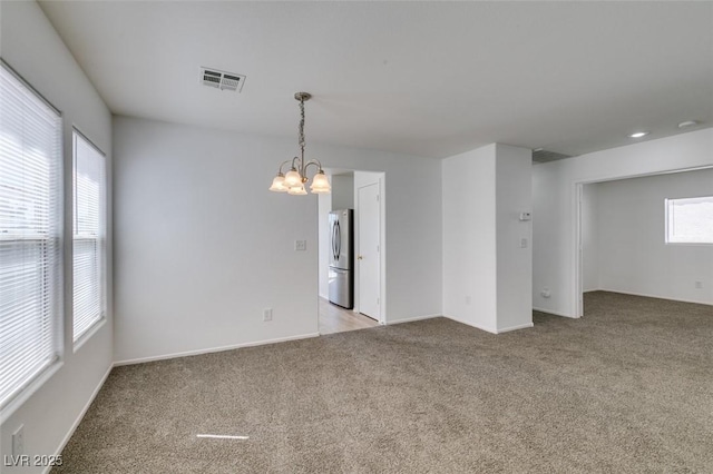 8877 Perfect Diamond Ct, Las Vegas, NV 89129 - unfurnished room with baseboards, light carpet, a chandelier, and visible vents