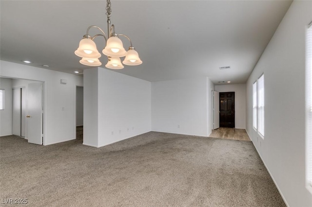 8877 Perfect Diamond Ct, Las Vegas, NV 89129 - carpeted spare room with an inviting chandelier, baseboards, a healthy amount of sunlight, and visible vents
