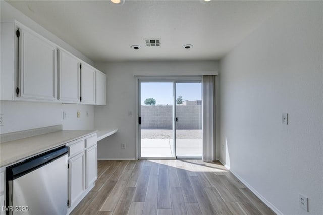 8877 Perfect Diamond Ct, Las Vegas, NV 89129 - kitchen featuring light wood-style floors, light countertops, dishwasher, and white cabinets