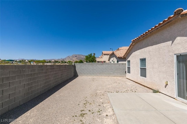 8877 Perfect Diamond Ct, Las Vegas, NV 89129 - view of yard featuring a fenced backyard, a mountain view, and a patio area