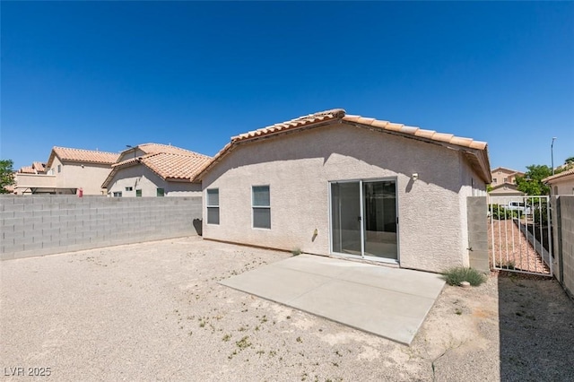 8877 Perfect Diamond Ct, Las Vegas, NV 89129 - back of property featuring a fenced backyard, a patio area, stucco siding, and a tile roof