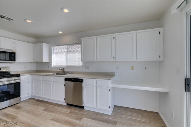 8877 Perfect Diamond Ct, Las Vegas, NV 89129 - kitchen featuring white cabinets, appliances with stainless steel finishes, a sink, recessed lighting, and visible vents
