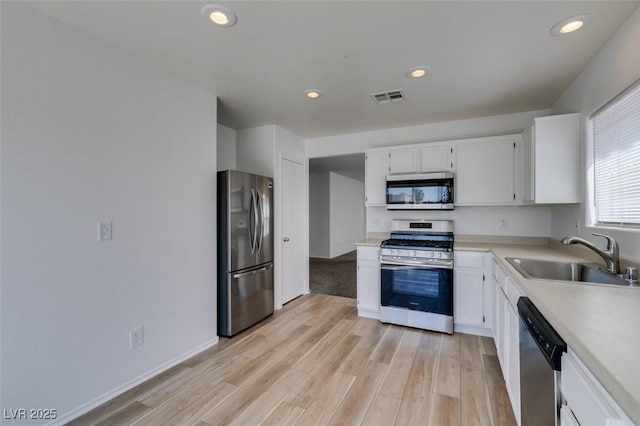 8877 Perfect Diamond Ct, Las Vegas, NV 89129 - kitchen featuring visible vents, a sink, light countertops, light wood finished floors, and stainless steel appliances