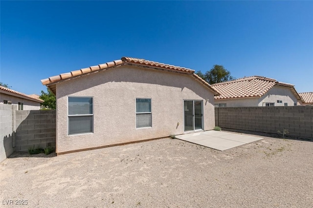 8877 Perfect Diamond Ct, Las Vegas, NV 89129 - back of property featuring a fenced backyard, stucco siding, a patio area, and a tile roof