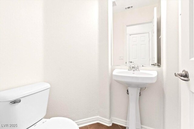 half bathroom with toilet and visible vents