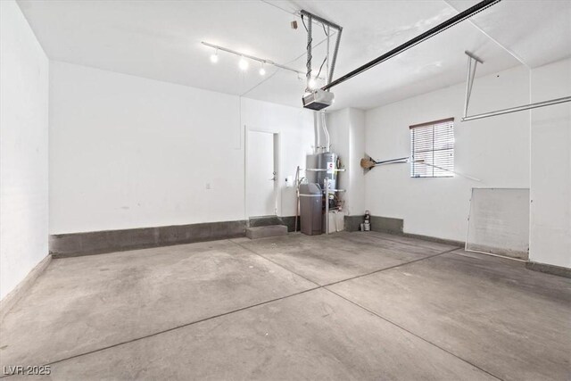garage featuring water heater and a garage door opener
