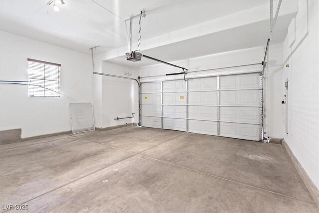 garage featuring baseboards and a garage door opener