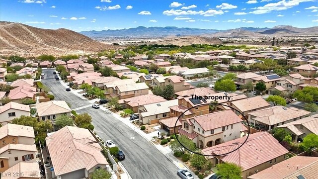 drone / aerial view with a residential view and a mountain view