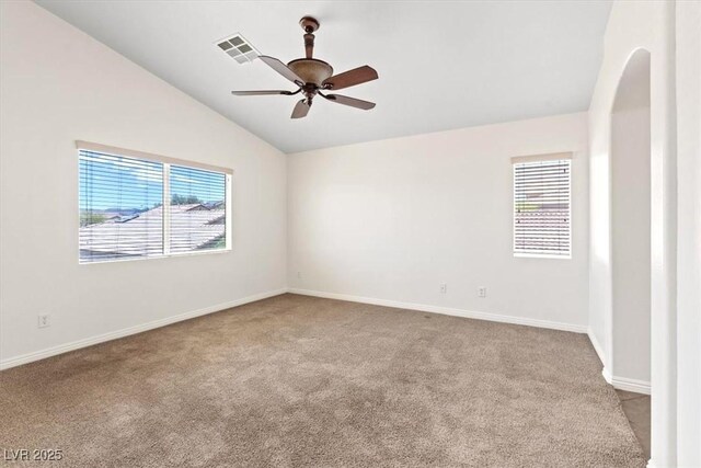 carpeted spare room with baseboards, ceiling fan, lofted ceiling, and a wealth of natural light