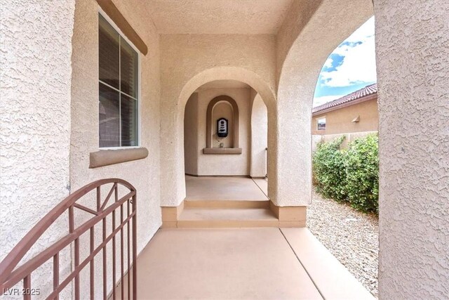 entrance to property with stucco siding