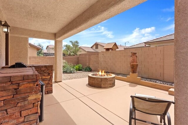 view of patio / terrace featuring a fenced backyard and an outdoor fire pit