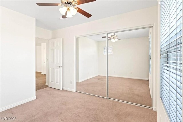 unfurnished bedroom featuring a closet, carpet, and baseboards