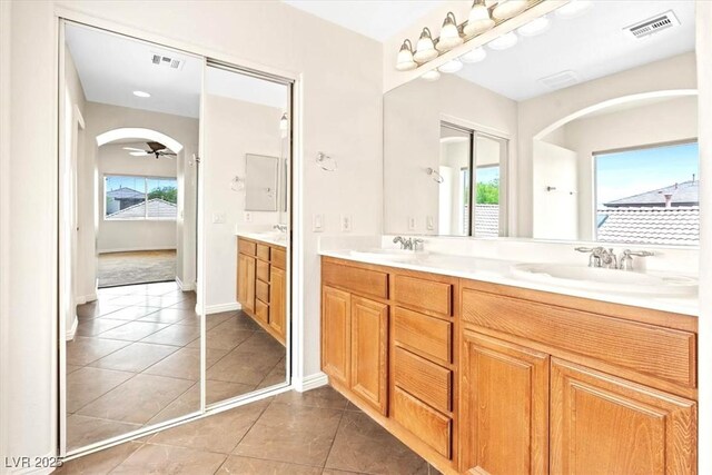 bathroom featuring double vanity, plenty of natural light, a sink, and visible vents