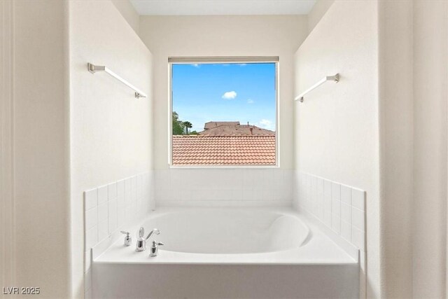 bathroom with a garden tub