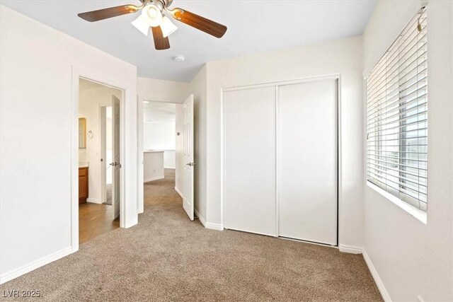 unfurnished bedroom featuring carpet floors, a ceiling fan, baseboards, and a closet