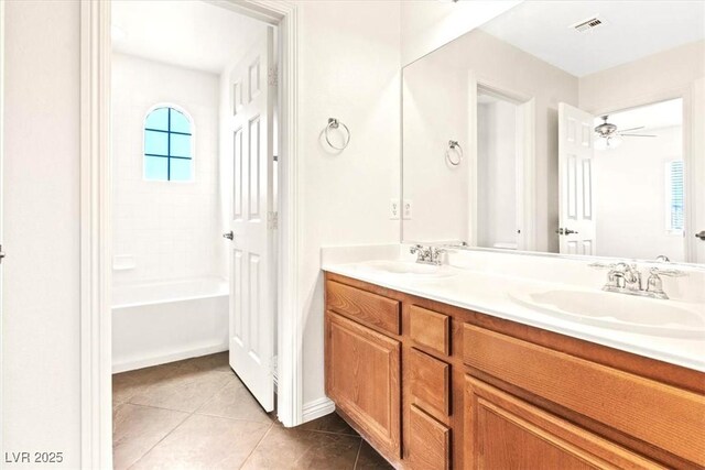 full bathroom with double vanity, visible vents, a sink, and tile patterned flooring