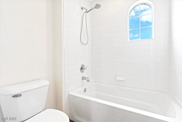 bathroom featuring toilet and shower / tub combination