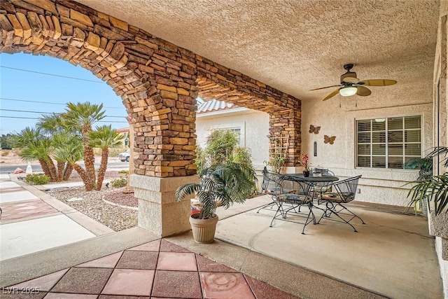 view of patio with a ceiling fan and outdoor dining space