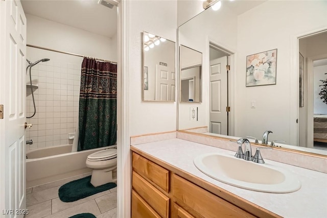 bathroom with visible vents, tile patterned flooring, shower / bath combo, vanity, and toilet