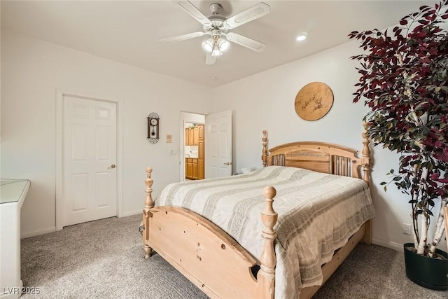 carpeted bedroom featuring baseboards and ceiling fan