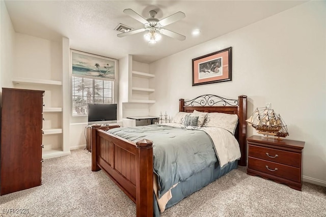 bedroom with visible vents, baseboards, ceiling fan, and light carpet