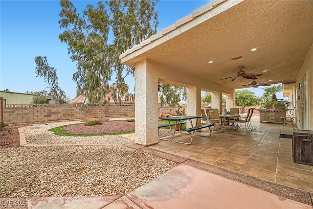 view of patio with a fenced backyard, outdoor dining area, and ceiling fan