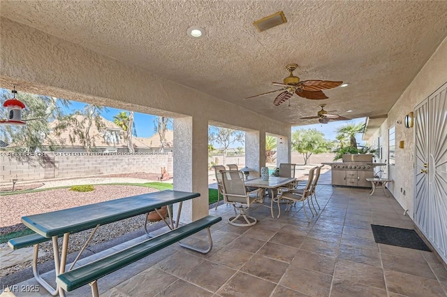 view of patio / terrace featuring outdoor dining area, a fenced backyard, and ceiling fan