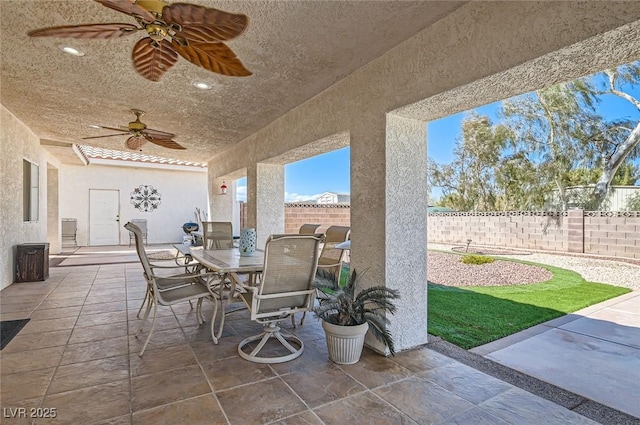 view of patio / terrace featuring a fenced backyard, ceiling fan, and outdoor dining space