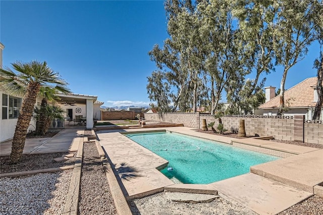 view of swimming pool with a fenced in pool, a ceiling fan, a patio area, and a fenced backyard