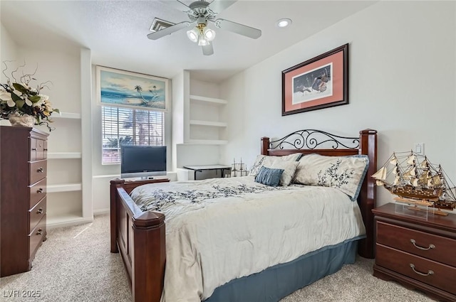 bedroom with ceiling fan and light carpet