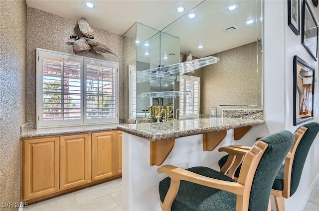 bar featuring visible vents, recessed lighting, and light tile patterned floors