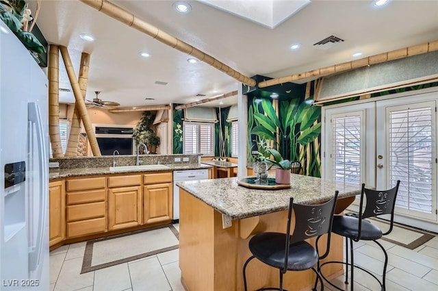 kitchen with a sink, white appliances, recessed lighting, light tile patterned floors, and visible vents