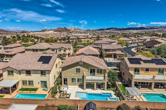 birds eye view of property with a mountain view and a residential view