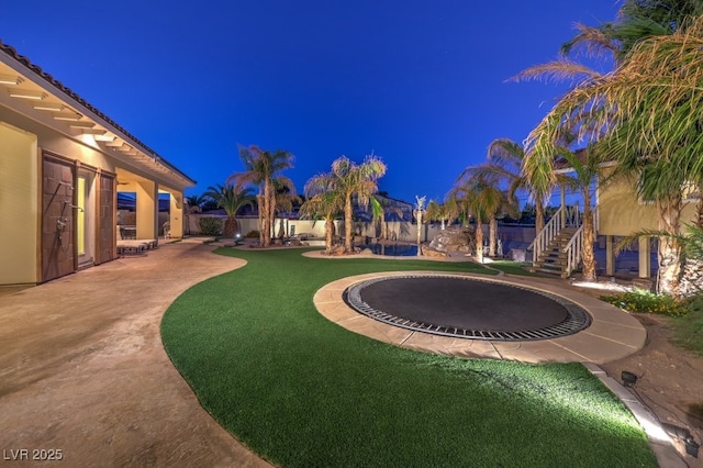 surrounding community featuring a yard, a patio area, and a trampoline